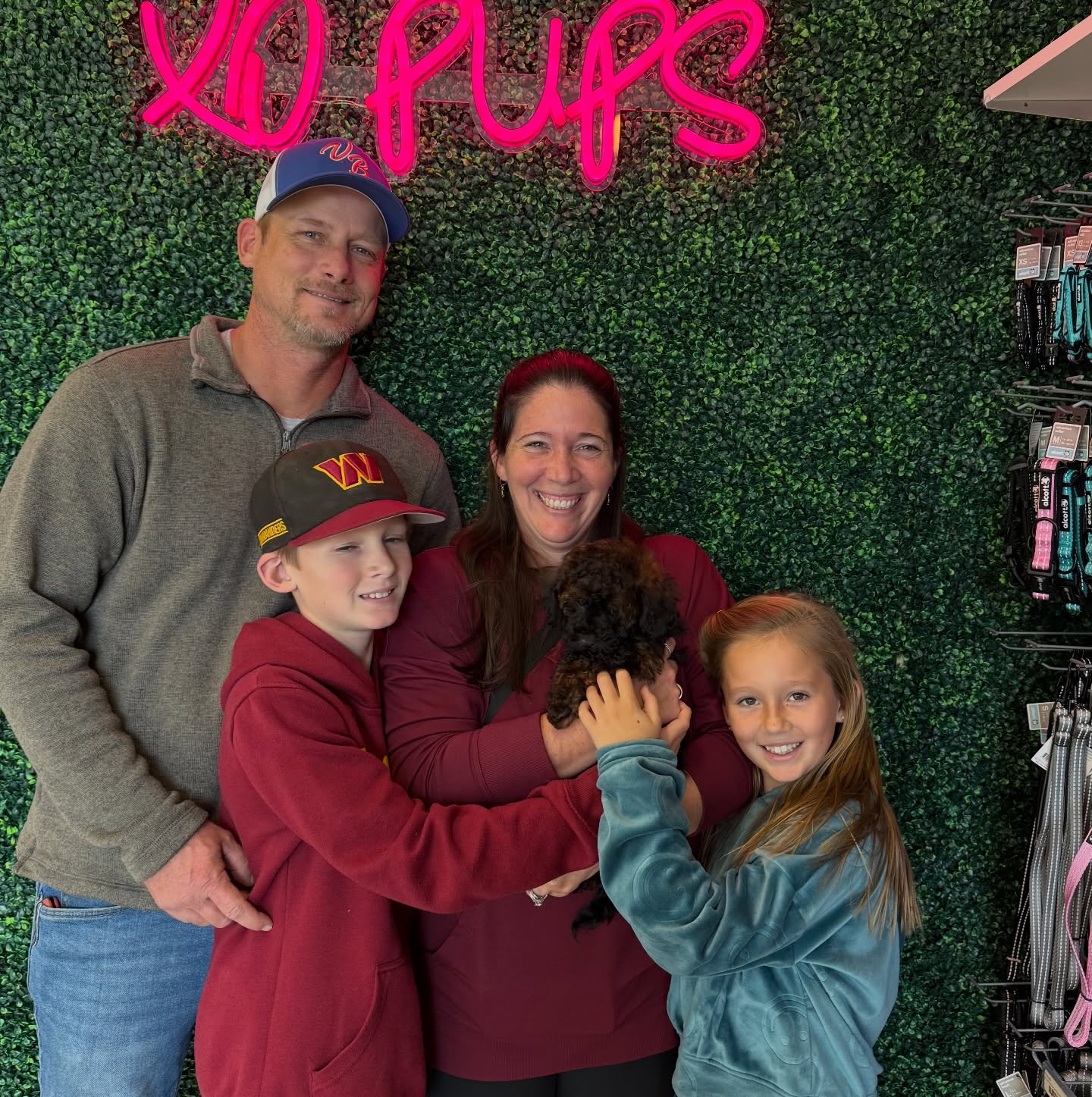 A family welcoming a puppy at XO PUPS